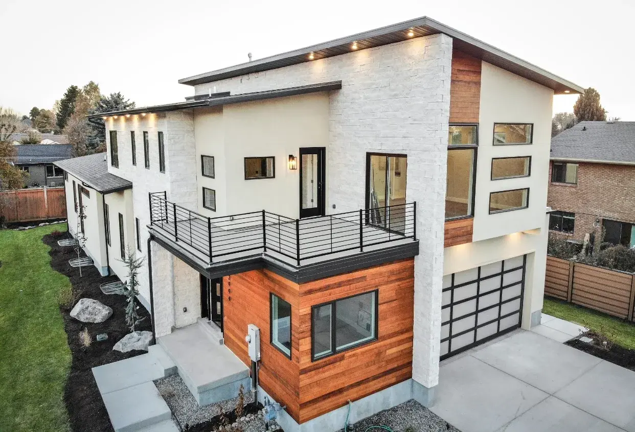 Current luxury new-construction project — stone and wood single-family build
